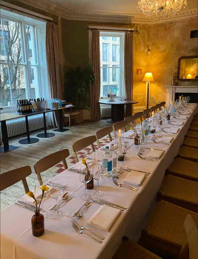 Elegant dining table with yellow flowers for corporate dinner or networking event.