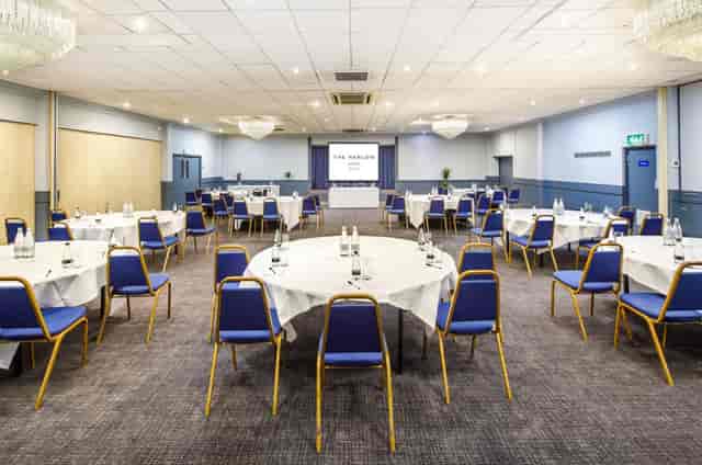 Buckinghamshire Suite at Harlow Hotel, set for a conference with round tables and projector.