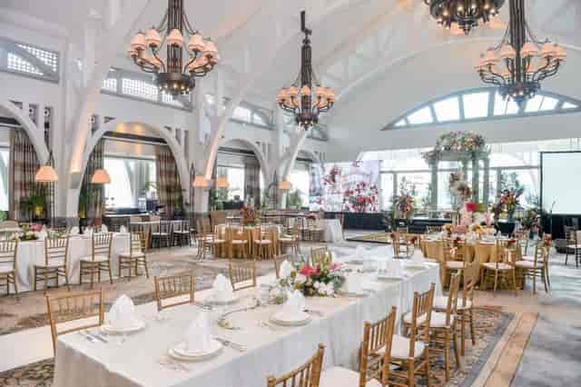 Elegant event space in HOST SINGAPORE with floral centerpieces, ideal for weddings and corporate events.