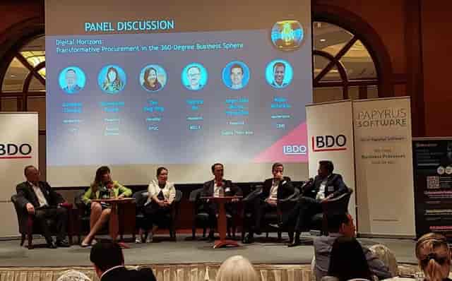 Panel discussion at BELLS Institute on transformative procurement, showcasing expert speakers.
