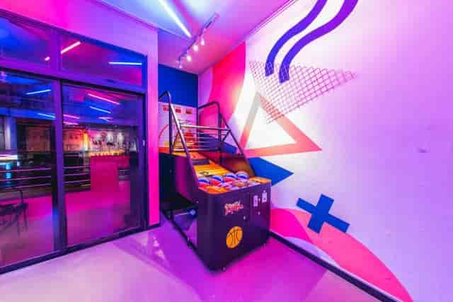 Indoor glasshouse cafe with neon lighting, perfect for casual gatherings and team-building events.