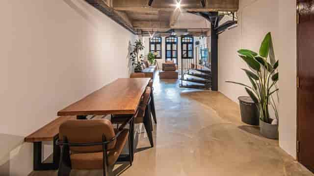 Modern event space at TERRA LOFT, featuring a long wooden table and natural light.