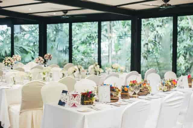 Elegant wedding venue at The Villa, Singapore Botanic Gardens with floral centerpieces.
