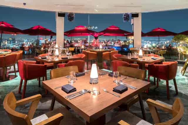 Rooftop restaurant in Marina Bay Sands with city skyline, perfect for upscale events.