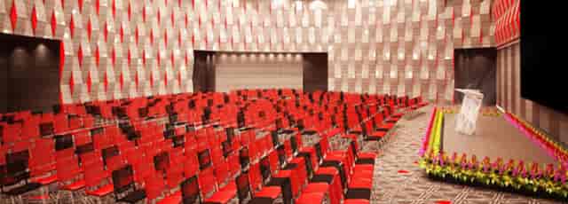 Main Hall at Park Avenue Convention Centre with red chairs for a conference setup.