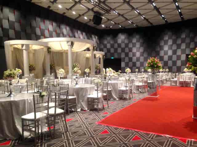 Elegant event space with round tables, floral centerpieces for weddings and corporate events.
