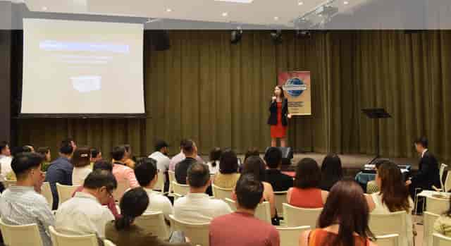 Professional speaker engaging audience in LISHA Tamil Toastmasters conference room seminar.
