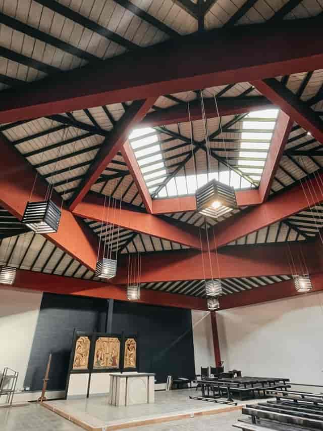 Sanctuary ceiling at Ascension Church Hulme, featuring geometric design and skylights for events.