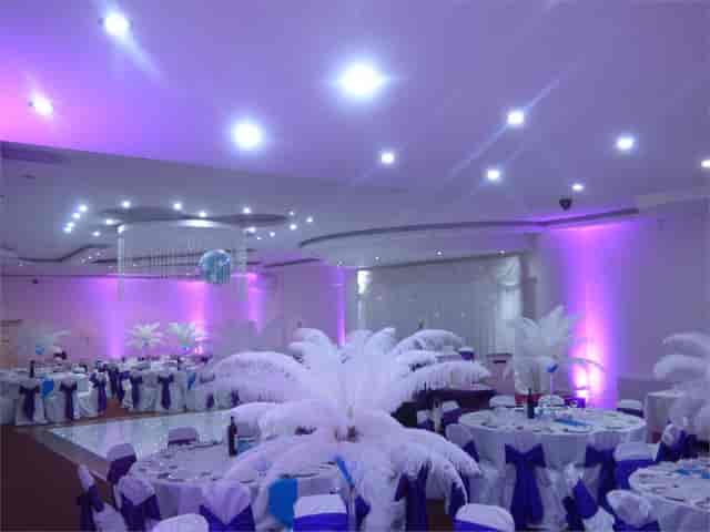 Elegance Banqueting Suite with feather centerpieces, perfect for formal events and celebrations.