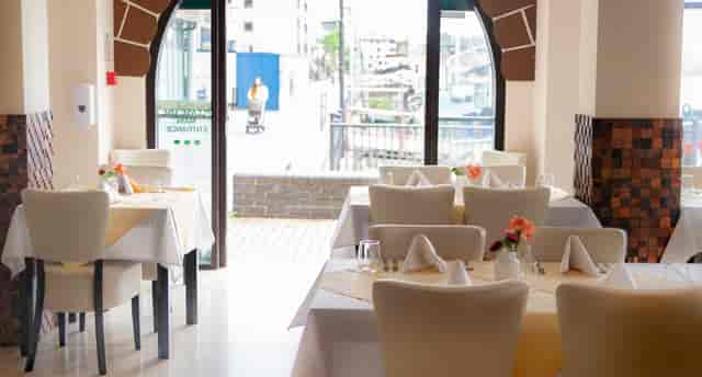 Private dining room at Grand Cholan, modern decor for intimate events and meetings.