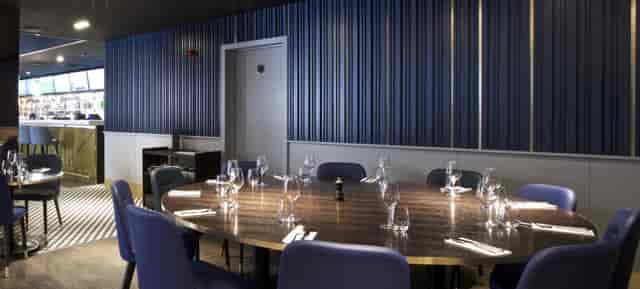 Private hire meeting space at Frankie's Sports Bar with elegant round table setup.