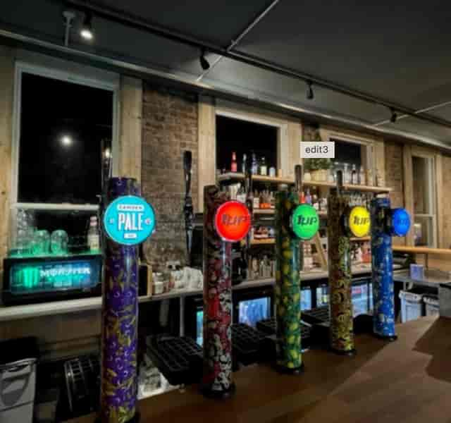 Vibrant bar with colorful beer taps at 1 Up Didsbury, ideal for events and gatherings.