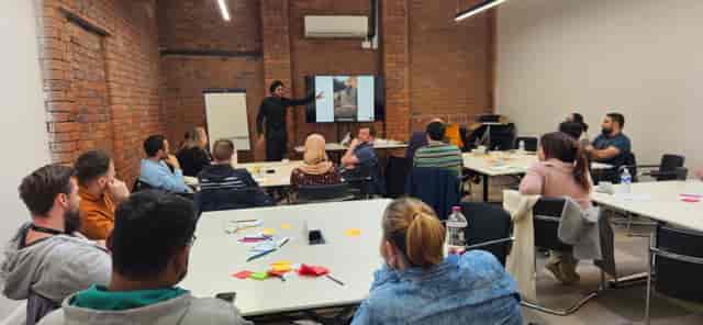 Dynamic workshop in Ram Mill, featuring brick walls and collaborative seating arrangements.