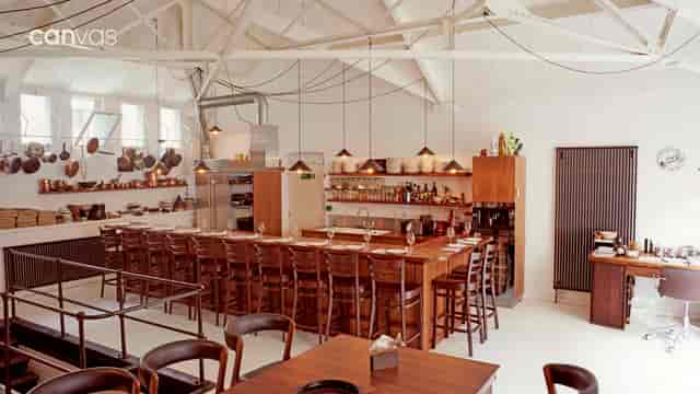 The Kitchen Library event space with a long bar, perfect for culinary gatherings.