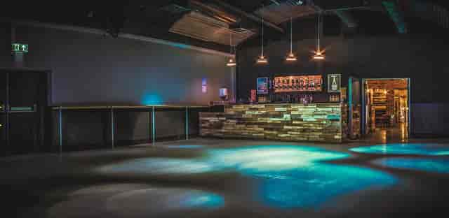 Modern event space with stylish bar, ideal for networking and social gatherings.