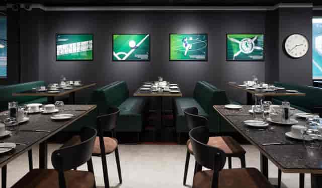 Modern dining space at Hibernian FC, featuring sleek tables for events and meetings.
