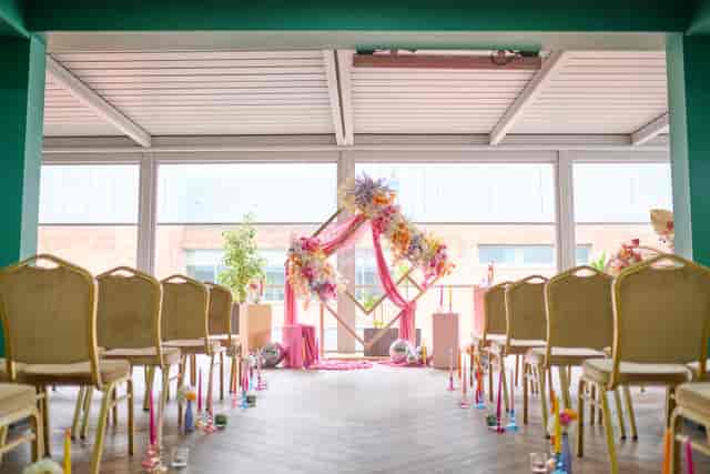 Garden Court in Manchester Hall with floral arch, perfect for weddings and ceremonies.