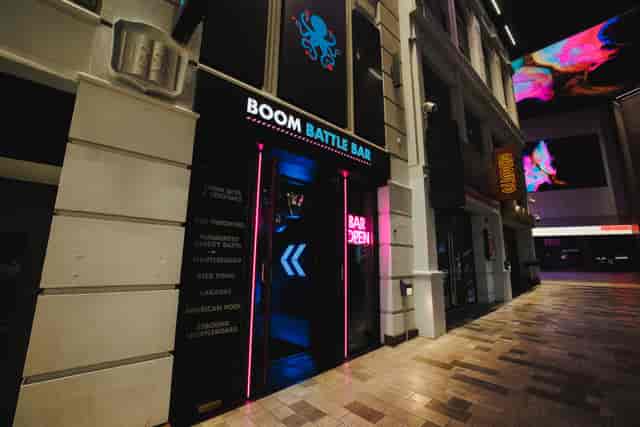 "Boom Battle Bar Manchester entrance with neon signage for team-building events"