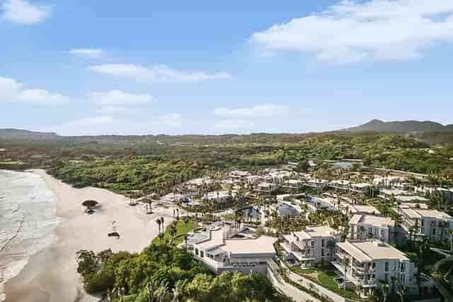 Resort Beach in Susurros del Corazón, ideal for events with lush greenery and beachfront access.