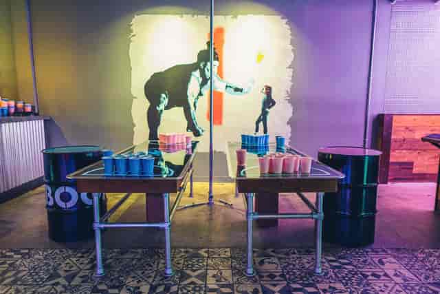 Vibrant event space with game tables for team-building parties in Birmingham.