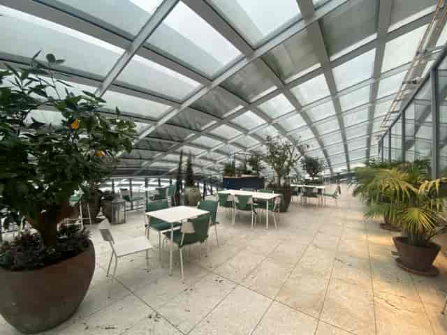 Fenchurch Terrace in Sky Garden London, modern event space with glass roof and greenery.