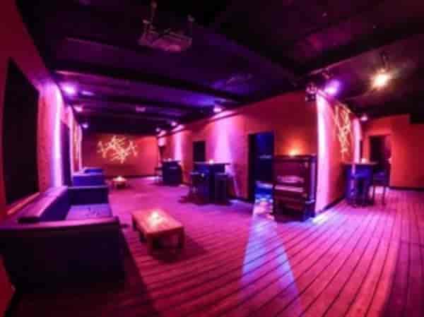 Stylish event space with purple lighting, ideal for networking and cocktail receptions.