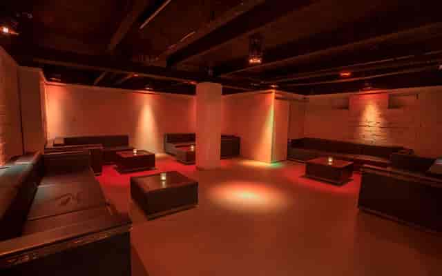Modern event space with ambient lighting, perfect for networking and private gatherings.