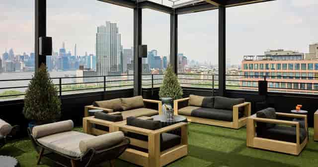 Stylish rooftop patio in Arlo Williamsburg, perfect for networking events and casual meetings.