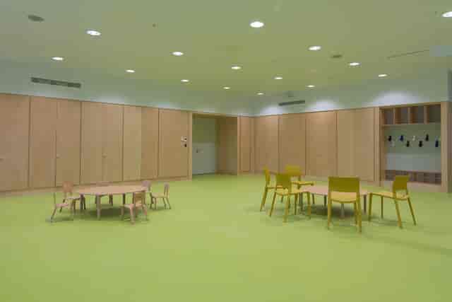 Versatile meeting space in Una Marson Library with vibrant green floor for workshops.