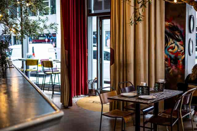 Stylish event space at Street Pizza St Paul's with cozy seating and vibrant decor.