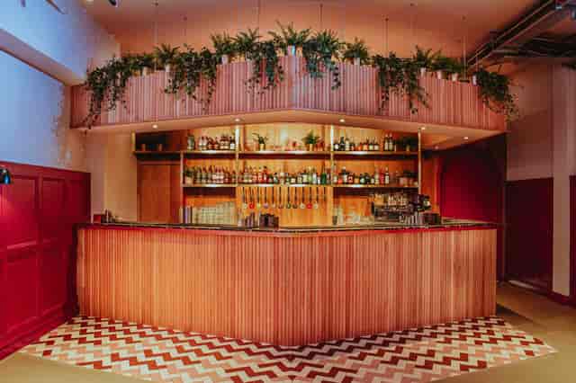 Main Bar & Terrace at Colours Hoxton with wooden counter, ideal for cocktail receptions.