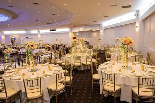 Elegant event space with floral centerpieces, perfect for weddings and formal gatherings.