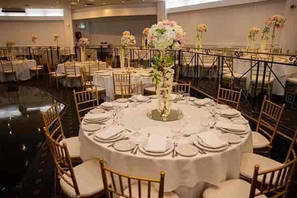 Elegant Pearl Ballroom with round tables, ideal for weddings and corporate events.
