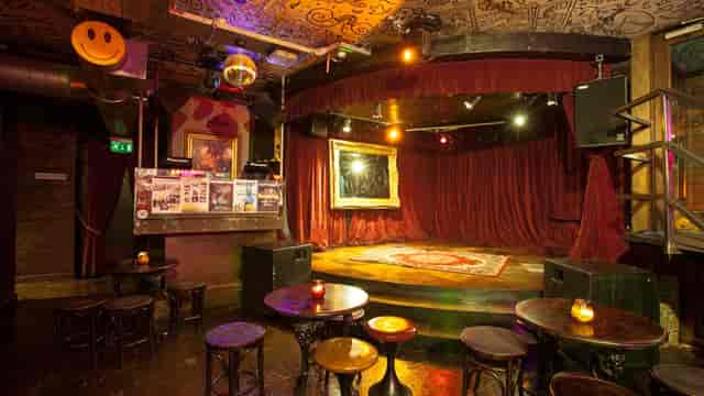 Vibrant music room with red curtains, perfect for live performances and creative events.