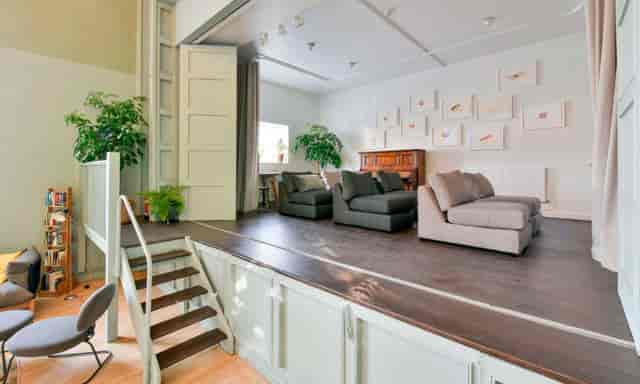 Versatile event space with seating at Refettorio Felix, ideal for gatherings and workshops.