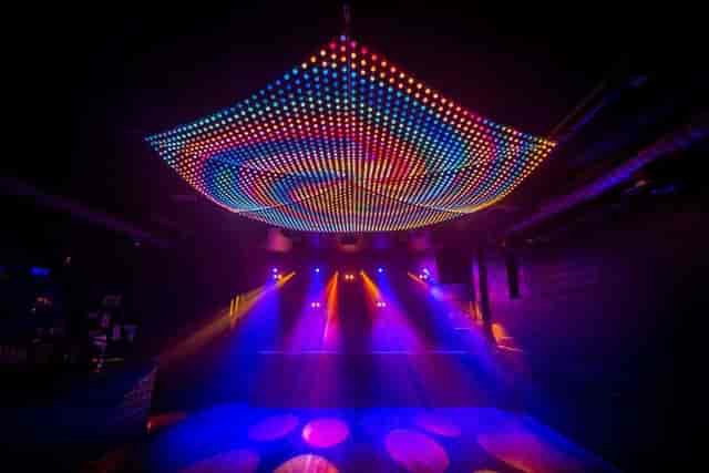 Vibrant Multiroom Event Space with LED lights for lively gatherings and dance events.