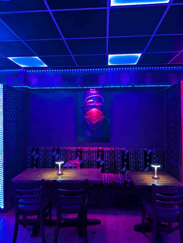 Vibrant Dream Lounge event space with bold lighting, ideal for networking and gatherings.