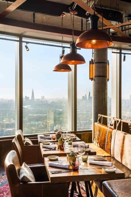 Stylish dining setup at Bōkan 38 Bar with city skyline, perfect for corporate events.