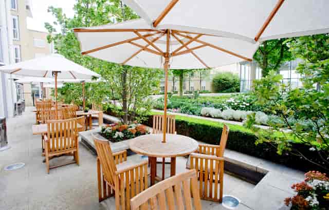 Serene outdoor terrace with wooden furniture at Canary Riverside Plaza for networking events.