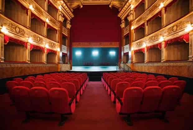 Moxie Theatre stage with plush red seating, ideal for performances and conferences.