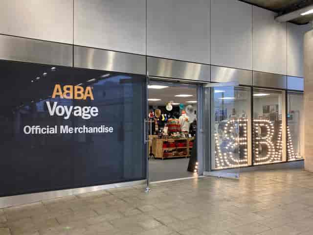 ABBA Voyage merchandise shop with vibrant signage for event marketing and attendee engagement.