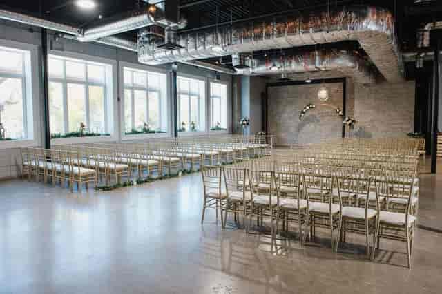 Elegant event space with gold chiavari chairs, perfect for weddings and gatherings.