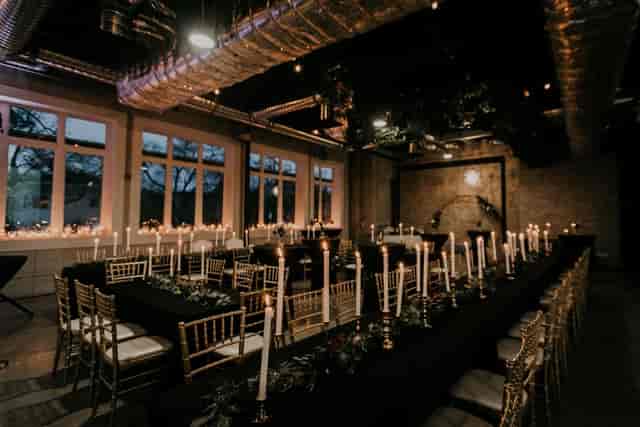 Elegant long table setup with candlelight for upscale dinners and corporate events.