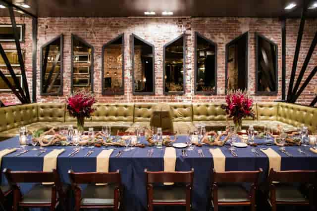 Elegant dining setup with navy linens for intimate restaurant buyout events.