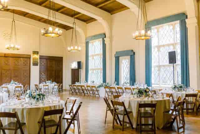 Elegant wedding venue with round tables and warm chandelier lighting in Berkeley City Club.