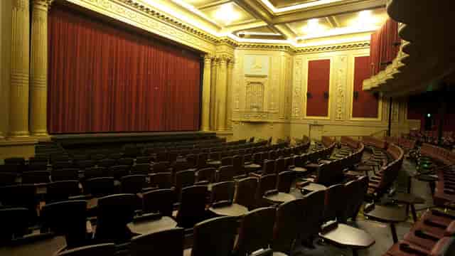 Alamo Drafthouse auditorium with red curtains, ideal for performances and corporate events.