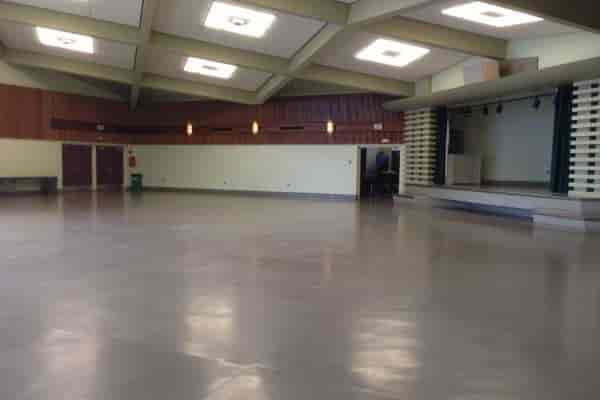 Spacious County Fair Building auditorium with polished concrete floor for events and gatherings.