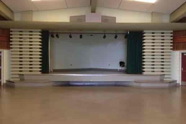 Versatile auditorium with raised stage, ideal for presentations and performances.