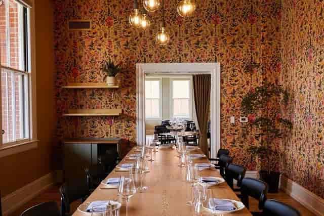 Private dining room with wooden table, ideal for corporate meetings and private dinners.