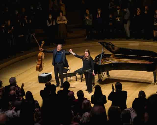"Campbell Recital Hall live performance with audience standing ovation, showcasing teamwork."